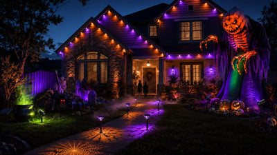 Five smart Halloween outdoor lights decorating a suburban yard at night